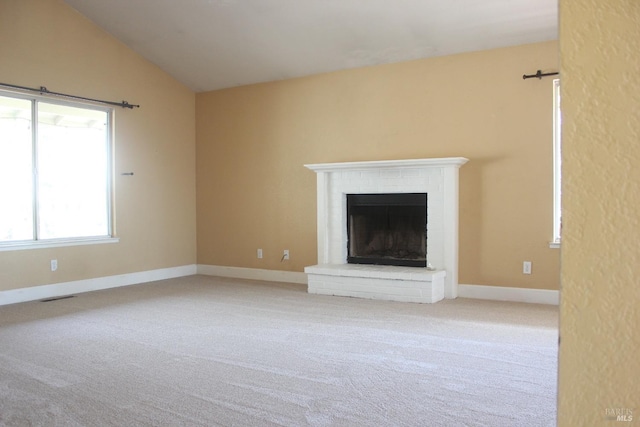 19207 Ravenhill Rd, Hidden Valley Lake, CA 95467 - unfurnished living room with lofted ceiling, carpet, visible vents, and a brick fireplace