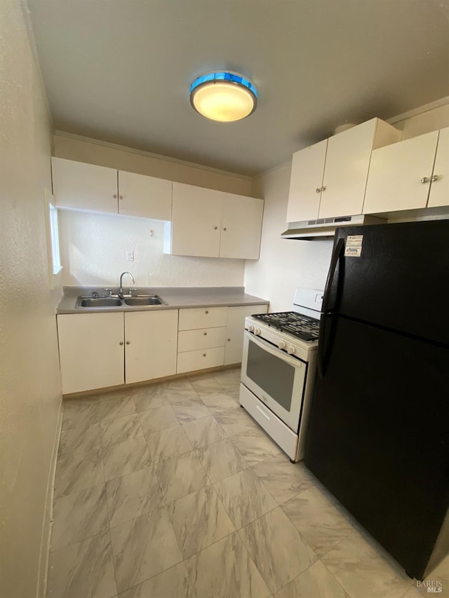 kitchen with a sink, freestanding refrigerator, under cabinet range hood, white range with gas cooktop, and white cabinetry