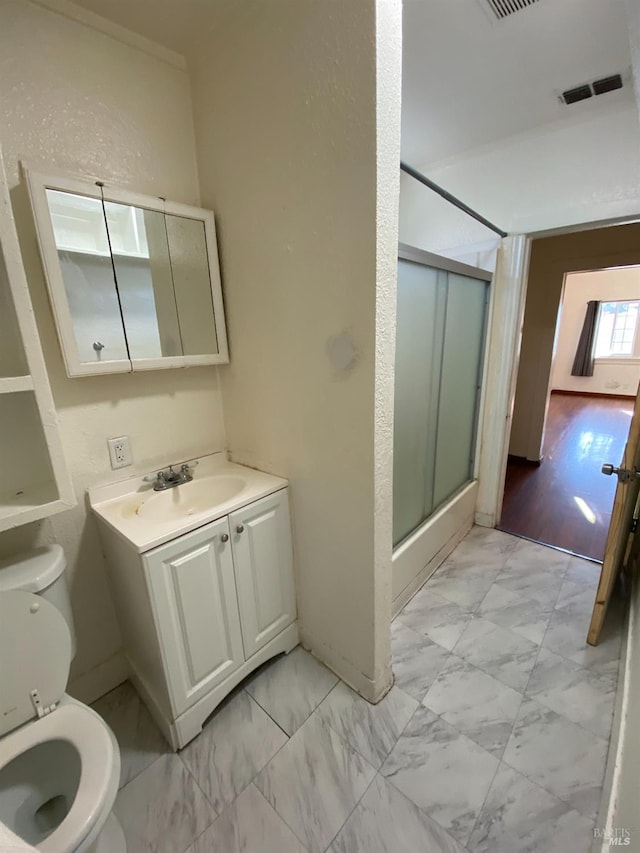 full bath featuring visible vents, toilet, vanity, marble finish floor, and a stall shower