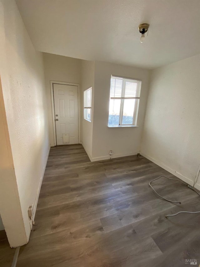 interior space featuring baseboards and wood finished floors