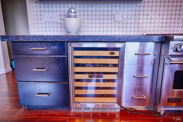 interior details featuring tasteful backsplash, wine cooler, and dark wood-type flooring