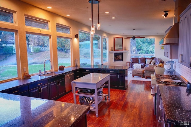 kitchen featuring stainless steel appliances, a wealth of natural light, sink, and pendant lighting