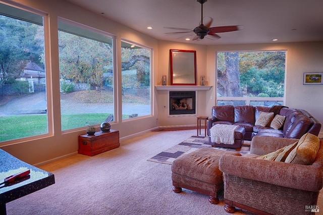 living room with ceiling fan and light colored carpet