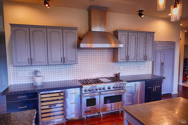 kitchen featuring double oven range, wall chimney range hood, beverage cooler, and tasteful backsplash