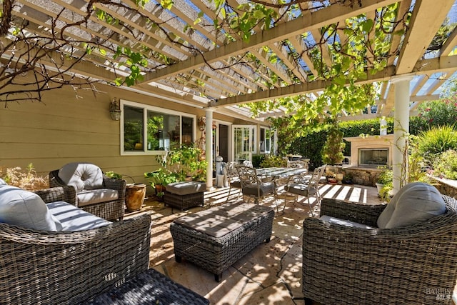 view of patio featuring an outdoor living space with a fireplace and a pergola