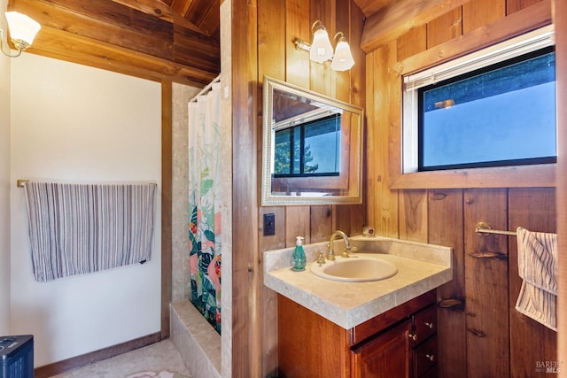 bathroom with a shower with curtain, wood walls, and vanity