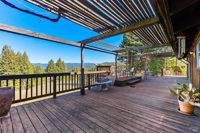 wooden terrace featuring a mountain view and a pergola