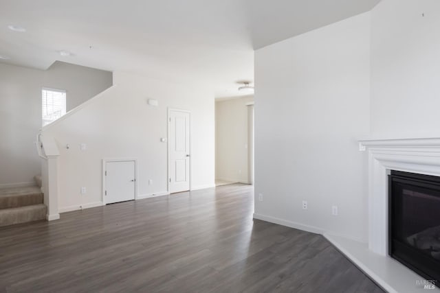 unfurnished living room with dark hardwood / wood-style flooring