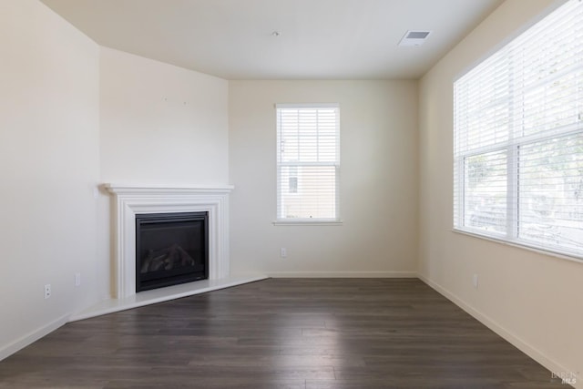 unfurnished living room featuring dark hardwood / wood-style floors