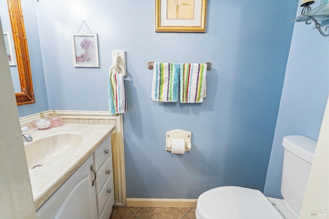 bathroom featuring tile patterned floors, vanity, and toilet