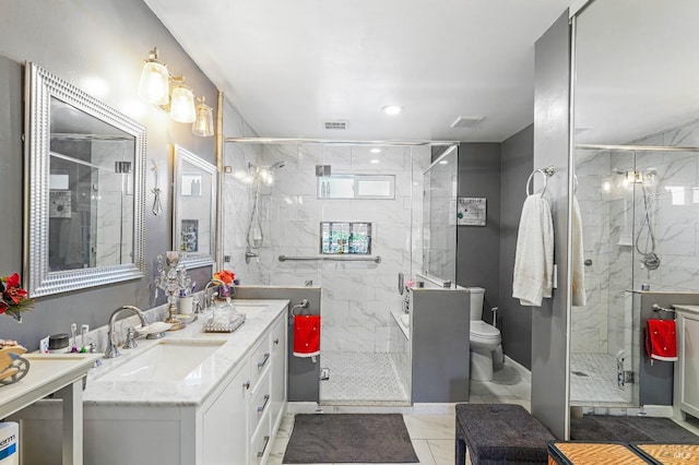 bathroom with tile patterned floors, vanity, an enclosed shower, and toilet