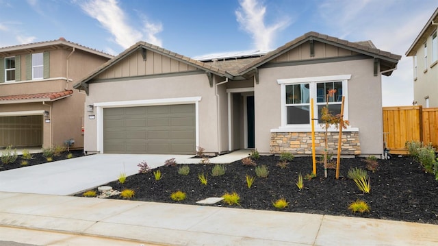 view of front of home with a garage and solar panels