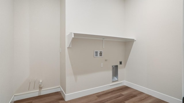 clothes washing area featuring hookup for a gas dryer, hookup for an electric dryer, hardwood / wood-style flooring, and washer hookup