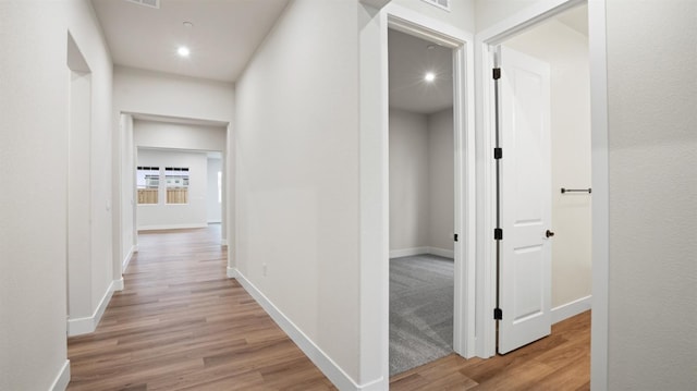 corridor with light hardwood / wood-style flooring