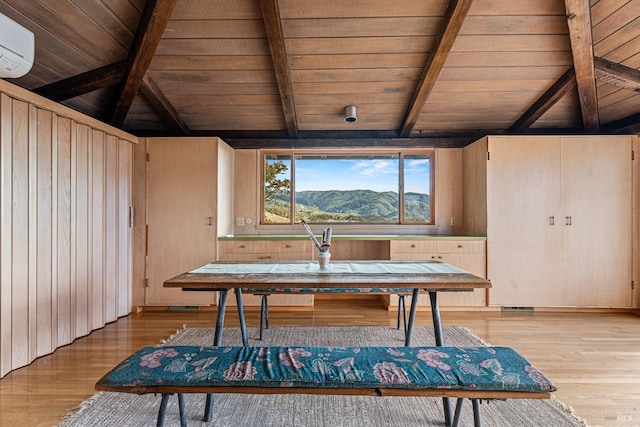 misc room featuring a mountain view, wooden ceiling, wooden walls, a wall mounted AC, and wood-type flooring