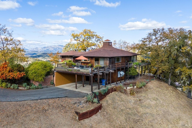 back of house featuring a deck with mountain view