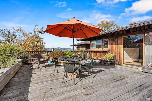 wooden deck featuring a mountain view