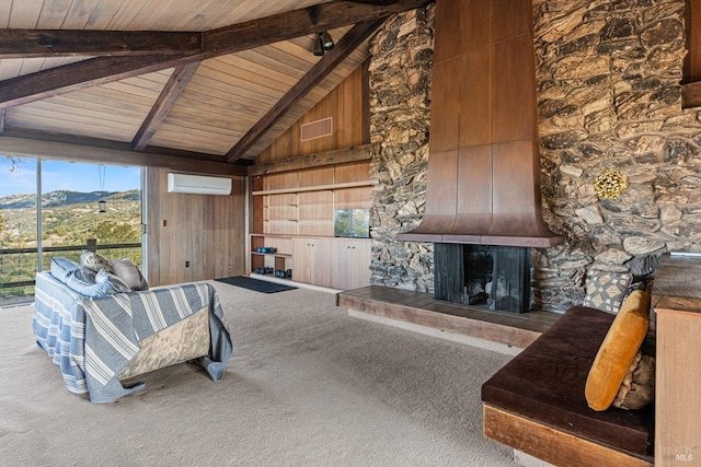 living room featuring carpet flooring, wooden ceiling, a mountain view, a stone fireplace, and wood walls