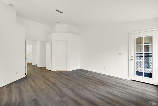 spare room featuring dark wood-type flooring