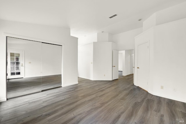 unfurnished living room with dark wood-type flooring