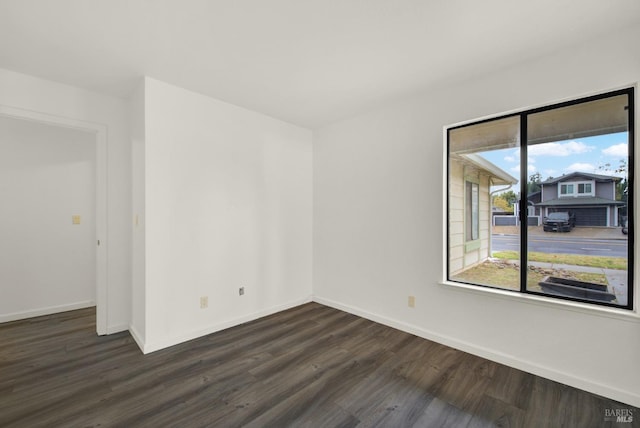 unfurnished room featuring dark hardwood / wood-style flooring