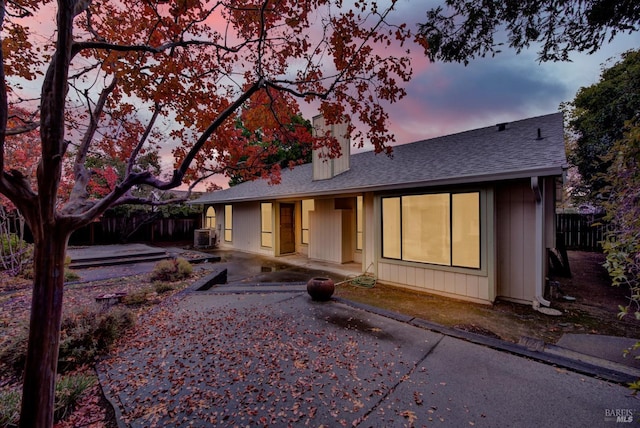 view of front of home with central AC unit and a patio