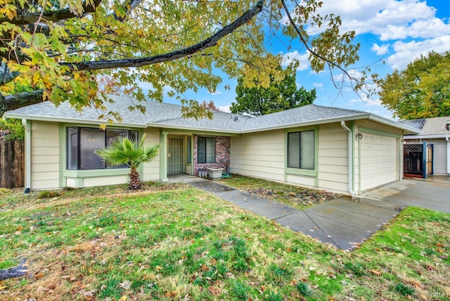 single story home with a garage and a front yard