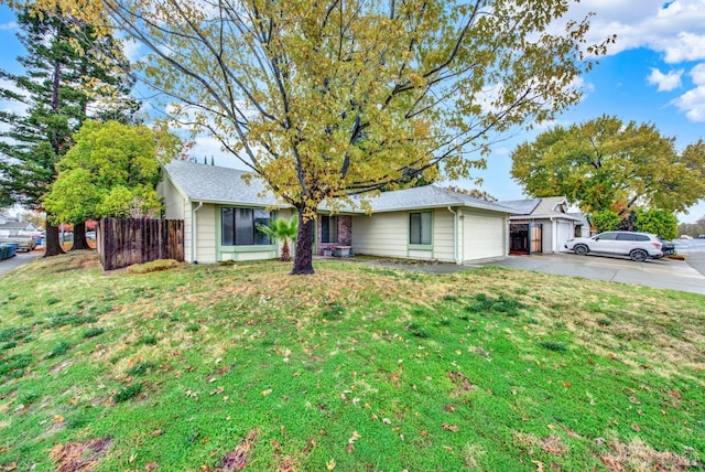 ranch-style home with a front yard and a garage