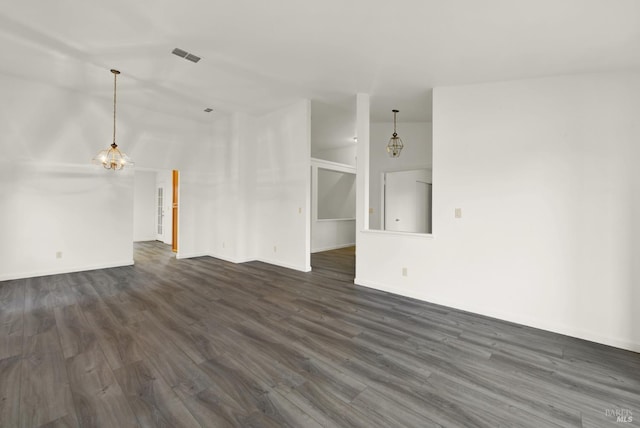 unfurnished living room with vaulted ceiling and dark hardwood / wood-style floors