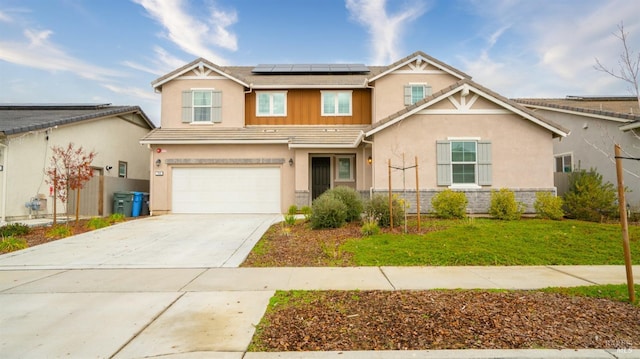 view of front of house with a garage, a front lawn, and solar panels