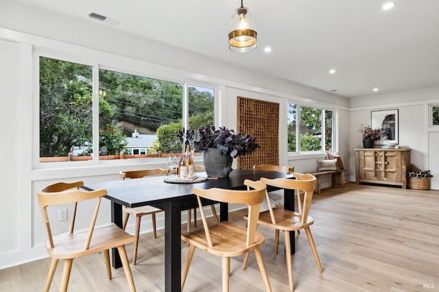 dining area with a wealth of natural light and light hardwood / wood-style flooring