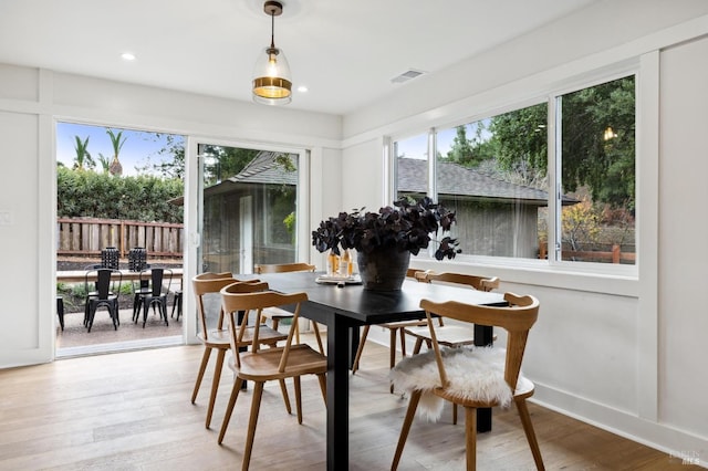 dining area featuring a healthy amount of sunlight and hardwood / wood-style flooring