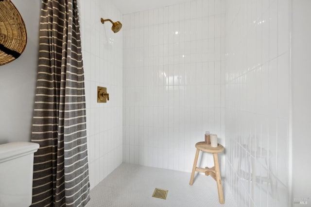 bathroom with toilet and walk in shower