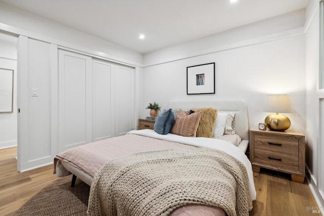 bedroom featuring a closet and light hardwood / wood-style floors