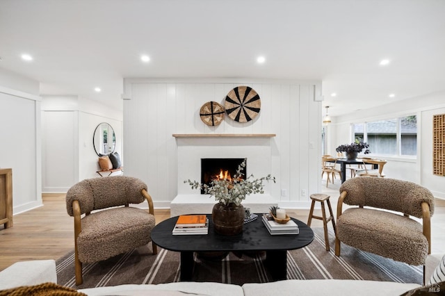 living room with hardwood / wood-style floors and wood walls