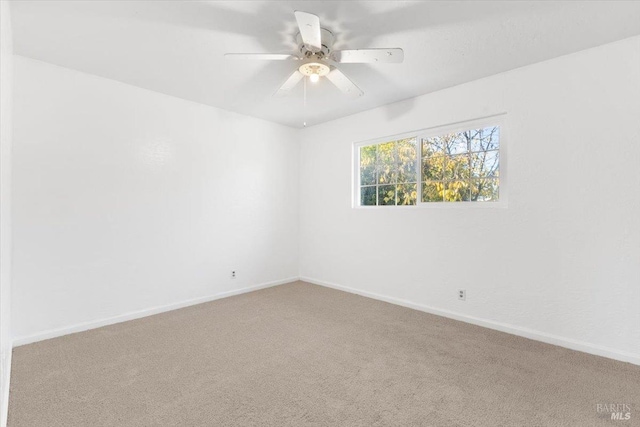 unfurnished room with baseboards, ceiling fan, and carpet flooring