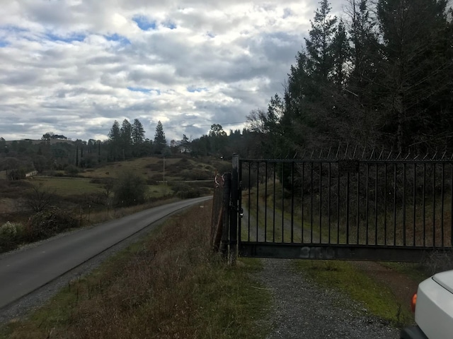 view of gate with a rural view