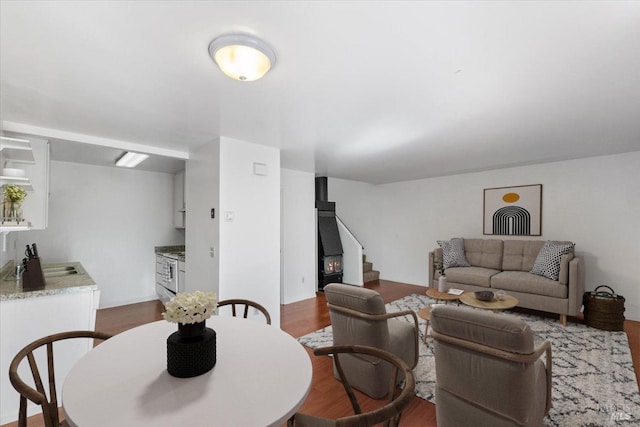 living room featuring sink and dark wood-type flooring