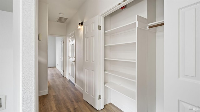 corridor with dark hardwood / wood-style floors