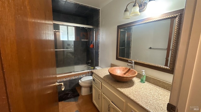 full bathroom featuring combined bath / shower with glass door, tile patterned floors, vanity, and toilet