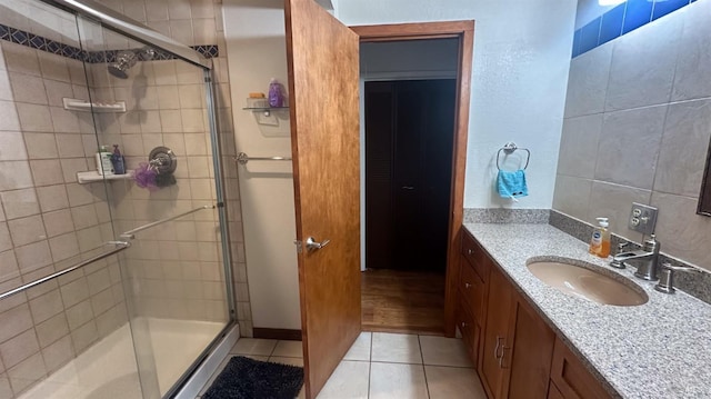 bathroom with vanity, tile patterned floors, and an enclosed shower