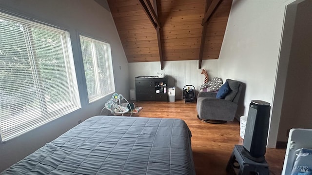 bedroom featuring lofted ceiling with beams, wood-type flooring, and wooden ceiling