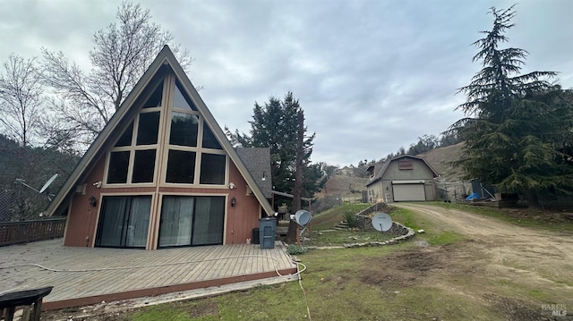 back of property with a lawn and a garage