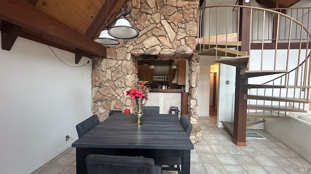 dining space featuring beamed ceiling and wooden ceiling