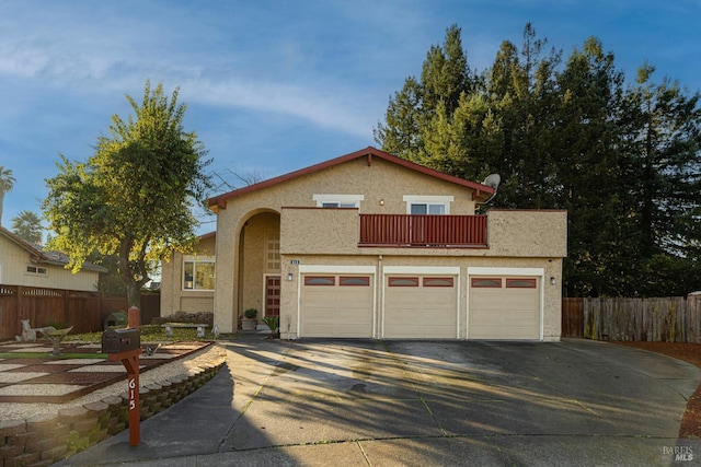 view of front facade with a balcony and a garage