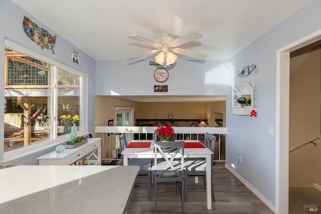 dining space with ceiling fan and dark wood-type flooring