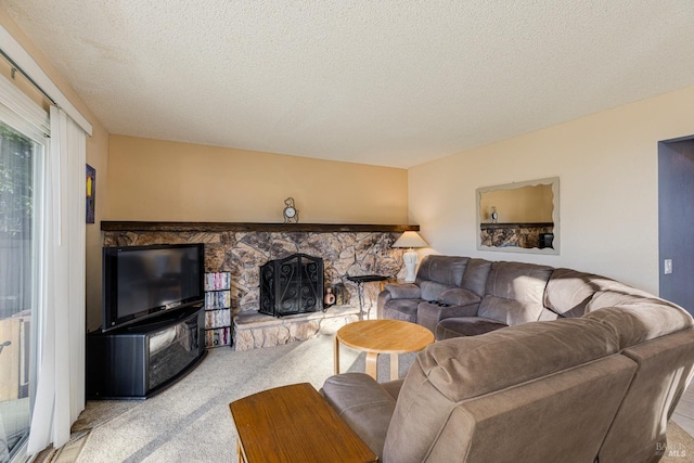 living room featuring a textured ceiling, light colored carpet, and a stone fireplace