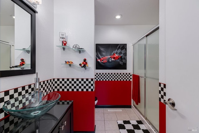 bathroom featuring tile patterned flooring, vanity, and a shower with shower door