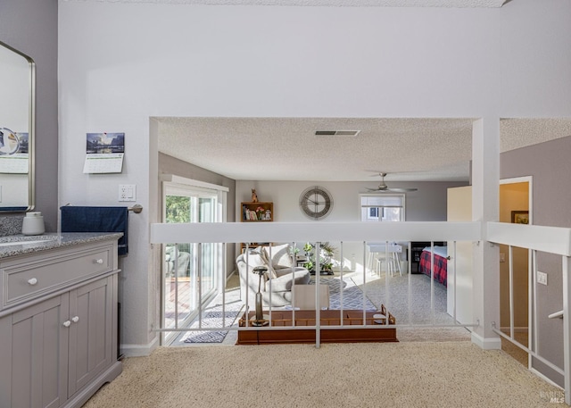 dining space with ceiling fan and a textured ceiling