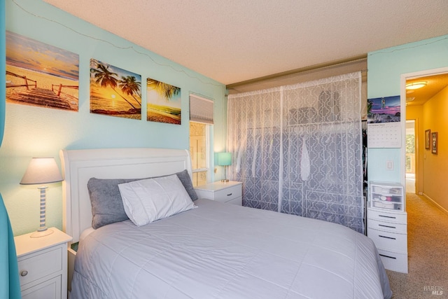 carpeted bedroom with a textured ceiling